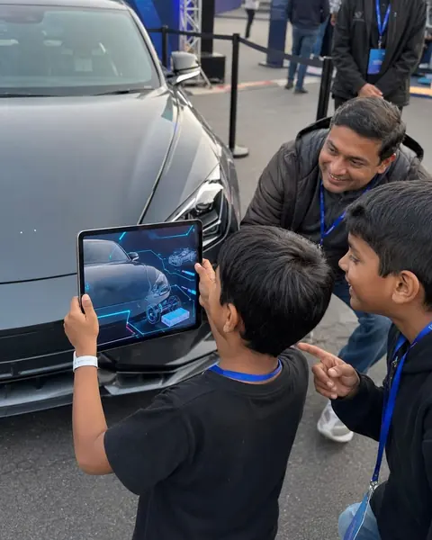 A kid holding a tablet with an augmented reality view of a car